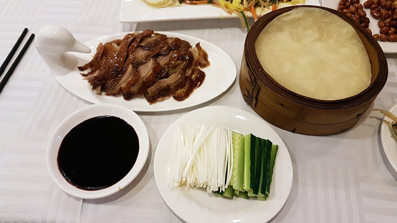 Sliced Peking duck served with pancakes and scallions